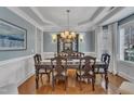 Elegant dining room featuring hardwood floors, chandelier, and sophisticated wall decor at 317 Briarfield Dr, Apex, NC 27502