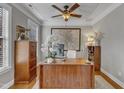 Well-lit home office with hardwood floors, built-in storage, and modern desk at 317 Briarfield Dr, Apex, NC 27502