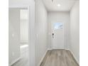 Bright hallway with light gray plank flooring and white trim at 3849 Rosebush Dr, Zebulon, NC 27597