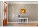 Elegant foyer featuring hardwood floors, decorative wall trim, and a stylish console table at 45 Melody Dr, Youngsville, NC 27596