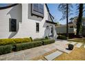 Charming white Tudor-style home featuring a front walkway and manicured landscaping at 5004 Lakemont Dr, Raleigh, NC 27609