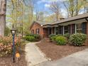 Beautiful brick home with professional landscaping and a curved walkway to the front door at 5130 Guess Rd, Durham, NC 27712