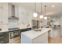 Modern kitchen with stainless steel appliances, quartz countertops, and a spacious island at 607 N Queen St, Durham, NC 27701