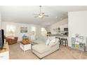 Open concept living room features a modern ceiling fan and flows into the kitchen at 733 Frosty Way, Zebulon, NC 27597
