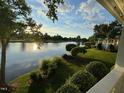 Picturesque lake view from the backyard, featuring mature trees and manicured landscaping at 737 Crabtree Crossing Pkwy, Cary, NC 27513