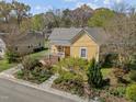 Charming home with lush landscaping, mature trees, and a welcoming front porch in a tranquil neighborhood setting at 907 Carolina Ave, Durham, NC 27705