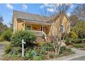 Beautiful exterior view of home highlighting the well-manicured lawn and inviting front porch and entrance at 907 Carolina Ave, Durham, NC 27705