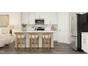 Modern white kitchen with stainless steel appliances and an island with seating at 1002 Sora Way, Durham, NC 27703