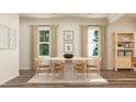 Bright dining room with table, chairs, neutral walls, and natural light from large windows at 1011 Red Roses Ave, Durham, NC 27703