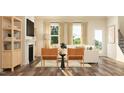 Bright living room with fireplace, hardwood floors, and natural light from large windows at 1011 Red Roses Ave, Durham, NC 27703