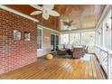 Inviting screened porch with wood ceiling, fan, and comfortable wicker furniture at 105 Fifemoor Ct, Cary, NC 27518