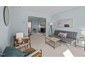 Comfortable living room with blue walls, carpeted floors, modern furniture, and decorative touches at 109 Boulder Ln, Chapel Hill, NC 27514