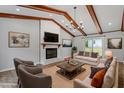 Staged living room with a brick fireplace, exposed beams, and stylish decor at 1107 Edgebrook Dr, Garner, NC 27529