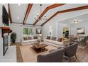 Spacious living room featuring a fireplace, modern lighting, and an open floor plan at 1107 Edgebrook Dr, Garner, NC 27529