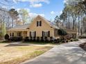 Charming one-story home with a covered porch, manicured lawn, and mature trees offering great curb appeal at 120 Teasel Ct, Clayton, NC 27527