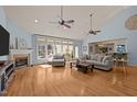 Bright and airy living room with hardwood floors, a fireplace, large windows, and vaulted ceilings at 120 Teasel Ct, Clayton, NC 27527