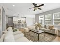 Open-concept living area with hardwood floors, modern decor, and a view of the kitchen island at 127 S Harrison Place Ln, Fuquay Varina, NC 27526