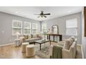Inviting living area with stylish decor, hardwood floors, and ample natural light from large windows at 127 S Harrison Place Ln, Fuquay Varina, NC 27526