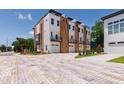 Modern townhomes with brick paved parking, garages, and private balconies at 1317 Garner Rd # 101, Raleigh, NC 27610