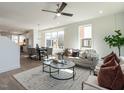Bright and open living room with stylish furniture, ceiling fan, and large windows providing natural light at 1317 Garner Rd # 101, Raleigh, NC 27610