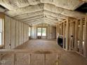 Spacious home interior with insulation, framed walls, fireplace, and large windows at 163 Grace Pond Ave, Benson, NC 27504