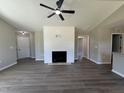Inviting living room with hard surface floors, a modern fireplace feature wall, and neutral paint at 163 Grace Pond Ave, Benson, NC 27504
