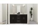 Modern bathroom featuring double vanity with dark wood cabinetry and sleek hardware, complemented by a white countertop at 1717 Goldfinch Perch Ln, Knightdale, NC 27545