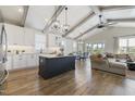 Open-concept kitchen with white cabinetry, island, stainless steel appliances, and hardwood floors at 1905 Cedar Dam Ln, Wendell, NC 27591