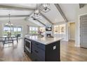 Open floor plan featuring kitchen island, living room with built-ins, fireplace, and dining area at 1905 Cedar Dam Ln, Wendell, NC 27591