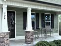 Inviting front porch with stone accents and outdoor seating area at 194 Cornfield Ln, Benson, NC 27504