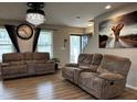 Spacious living room with hardwood floors and comfortable seating at 194 Cornfield Ln, Benson, NC 27504
