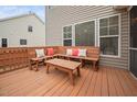 Outdoor wooden deck with a built-in bench and pillows is perfect for entertaining and relaxing at 2001 Lilly Brook St, Fuquay Varina, NC 27526