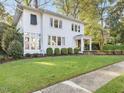 Charming two-story home with well-manicured lawn and mature trees providing shade at 2108 Myrtle Ave, Raleigh, NC 27608