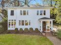 Charming two-story home with a well-manicured lawn and a walkway to the front door at 2108 Myrtle Ave, Raleigh, NC 27608