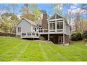Expansive backyard featuring a deck, patio and a glass enclosed sunroom providing ample space for activities at 2321 Mica Mine Ln, Wake Forest, NC 27587