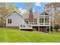 Beautiful backyard featuring a deck, patio and a glass enclosed sunroom perfect for outdoor entertaining at 2321 Mica Mine Ln, Wake Forest, NC 27587