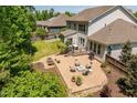 Enjoy the backyard with brick patio, firepit, and lush landscaping at 2421 Trenton Park Ln, Raleigh, NC 27607