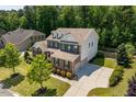 A lovely view of the home's architecture, driveway, and manicured lawn at 2421 Trenton Park Ln, Raleigh, NC 27607