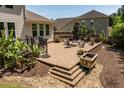 Beautiful outdoor patio with seating, stone fire pit, and manicured garden at 2421 Trenton Park Ln, Raleigh, NC 27607