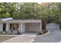 Exterior shows the house and a detached two-car garage. The property is surrounded by lush green trees at 245 Marilyn Cir, Cary, NC 27513