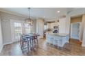 Eat-in kitchen featuring stainless appliances, granite counters, an island, and an adjacent dining area at 2540 Levi Ln, Bahama, NC 27503