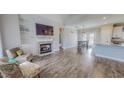Bright living room boasts hardwood floors, a fireplace, built-in shelving, and an open floor plan at 2540 Levi Ln, Bahama, NC 27503