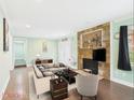 Cozy living room featuring a stone fireplace, neutral tones, and lots of natural light at 2920 Ode Turner Rd, Hillsborough, NC 27278