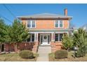 Charming two story brick home boasts mature trees, covered entrance and concrete steps at 301 E Umstead St, Durham, NC 27707