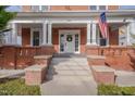 Inviting front porch with classic columns and brick accents, perfect for relaxing and enjoying the outdoors at 301 E Umstead St, Durham, NC 27707