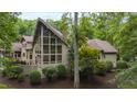 Stunning exterior of a luxury home showcasing large windows and beautiful landscaping at 301 Stone Currie Dr, Hillsborough, NC 27278