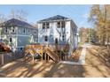 Backyard view of a two-story home with a spacious wooden deck and stairs at 306 Cecil St, Durham, NC 27707