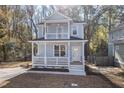 Charming two-story home with a welcoming front porch and white railings at 306 Cecil St, Durham, NC 27707