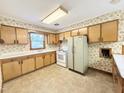 Bright eat-in kitchen featuring a vintage refrigerator and lots of storage at 310 Meadowbrook Dr, Burlington, NC 27215