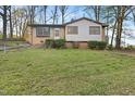 Charming brick and siding home with a well-maintained lawn and light blue shutters and trim at 3416 North Ridge Dr, Sanford, NC 27330